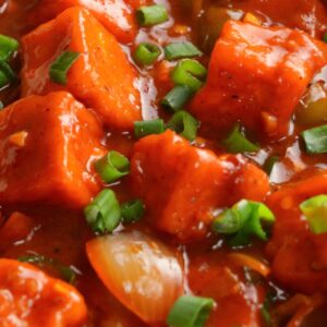 Chilli paneer gravy with capsicum and onions Spicy Indo Chinese paneer gravy dish Paneer cubes in rich chilli sauce gravy Restaurant style chilli paneer curry