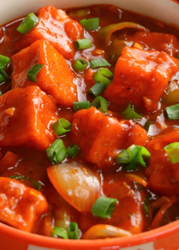 Chilli paneer gravy with capsicum and onions Spicy Indo Chinese paneer gravy dish Paneer cubes in rich chilli sauce gravy Restaurant style chilli paneer curry