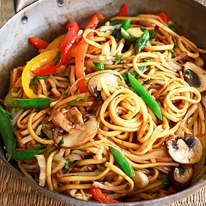 Veg noodles with fresh vegetables stir fry Indo Chinese vegetable noodles dish Hakka veg noodles with capsicum and carrot Street style veg noodles