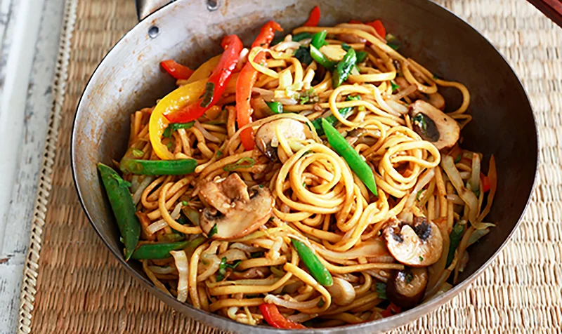 Veg noodles with fresh vegetables stir fry Indo Chinese vegetable noodles dish Hakka veg noodles with capsicum and carrot Street style veg noodles