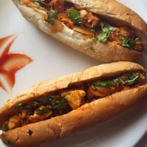 Veg Hot-Dog with fresh bun, veggie filling, and creamy sauces