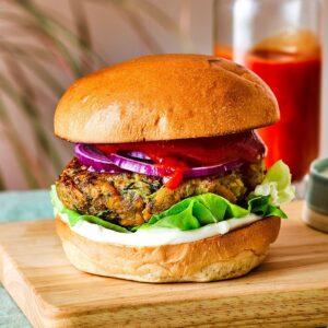 Veg burger with crispy vegetable patty Indian style aloo tikki burger Vegetable burger with lettuce and sauce Street style veg burger