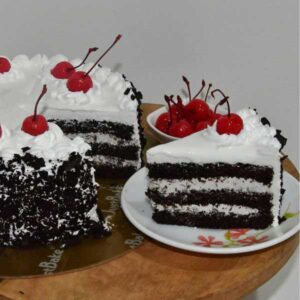 Black Forest Pastry chocolate cake slice with cream and cherry topping
